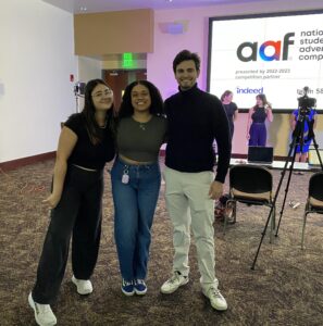 Arrowhead Advertising video team filming the 2023 competition dress rehearsal at the Turnbull Conference Center, featuring the presentation team and the official title slide on the main screen.